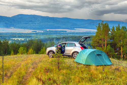 parking of autotourists at a gorgeous dawn in the Ural mountains on a summer day