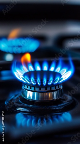 Two bright blue flames burn from gas burners on a stove
