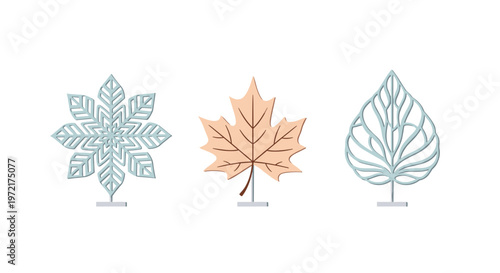 Three elegant decorative sculptures representing a snowflake and two different leaf shapes stand on minimalist silver pedestals against a white backdrop.