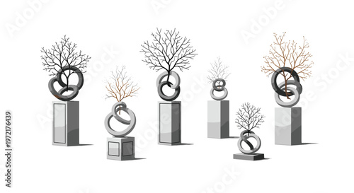 Elegant contemporary sculptures showcase delicate leafless trees growing through interlocking circular rings mounted on tall polished grey pedestals against a white backdrop.