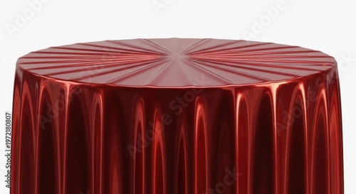 Red shiny tablecloth covering round table with elegant pleats and reflections.