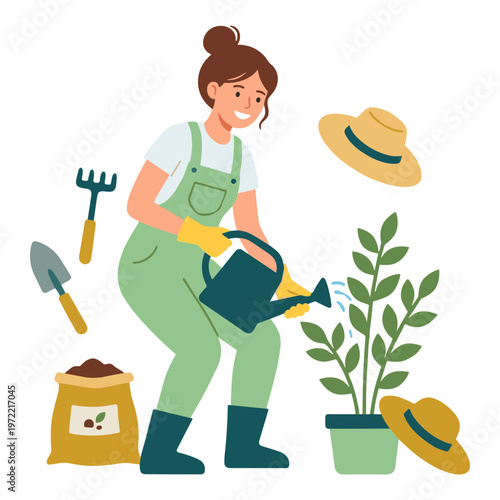 Woman gardening with tools watering plant in green overalls outdoors
