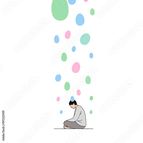 Young man sitting with head down.