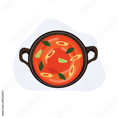 top view of a hot pot filled with tom yum soup, featuring chili, lime, and herbs, suitable for thai food menu,