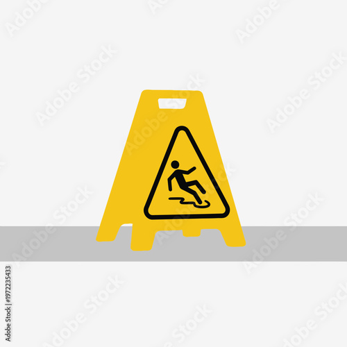 警告サインの黄色い立て看板で、滑って転倒する人のイラストが描かれている。