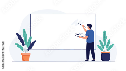 Male artist in a blue shirt standing at a large blank white canvas while holding a paintbrush and color palette.