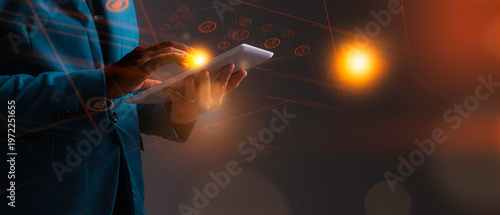 A futuristic Business man is holding a digital tablet, which a hologram is a graphic layout., Future Concept from Hologram.