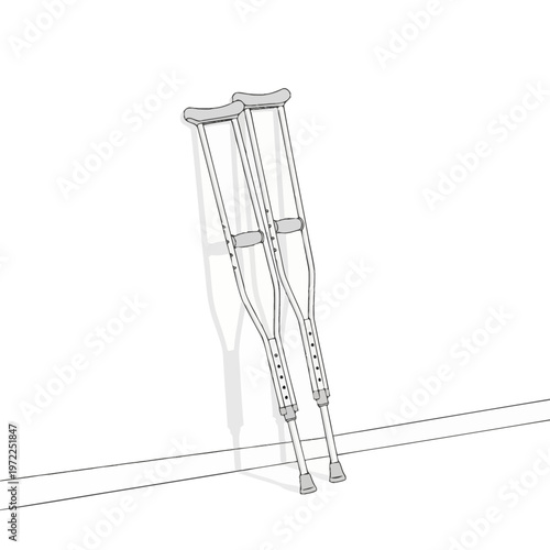 Pair of crutches leaning against a white wall with shadows cast.