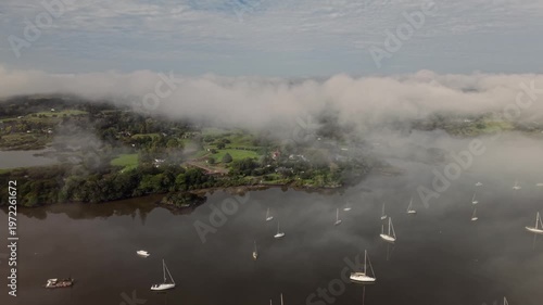 Aerial morning fog over boats in Kerikeri Inlet Bay of Islands New Zealand coastal landscape
