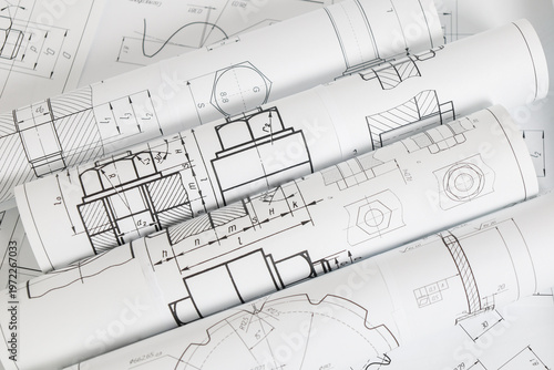paper engineering drawings of industrial parts and mechanisms