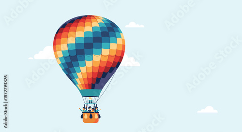Brightly colored hot air balloon with a group of people floats peacefully through a light blue sky dotted with soft white clouds.