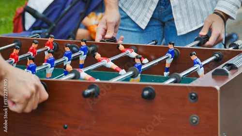 Enthusiasts Engaging in Intense Foosball Match
