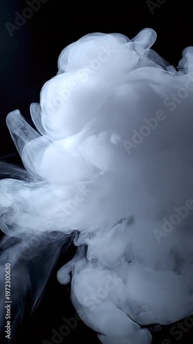 A dense stream of white smoke or vapor rising and swirling against a solid black background, creating turbulent wisps and ethereal patterns for use in visual effects.