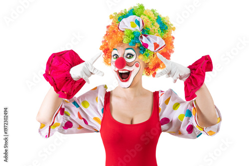 Funny female clown, woman entertainer dressed as a colorful Joker in a suit and wig, with clown whiteface makeup
