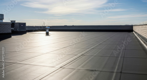 Flat commercial roof with EPDM rubber membrane installation highlighting durability and modern industrial design for construction and building maintenance projects under clear skie