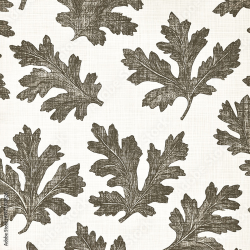 Hand-drawn oak leaves seamless pattern in a vintage engraved style on textured background.