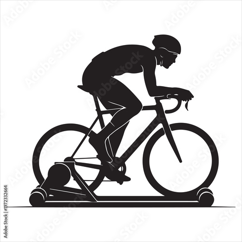 Silhouette of a cyclist training on an indoor stationary bike trainer for home fitness workout and professional triathlon preparation.