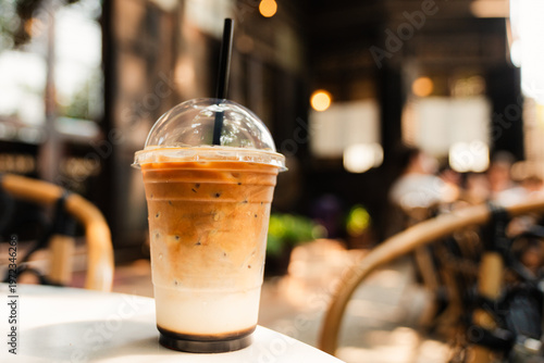 Iced Latte Coffee in Takeaway Cup on Cafe Table