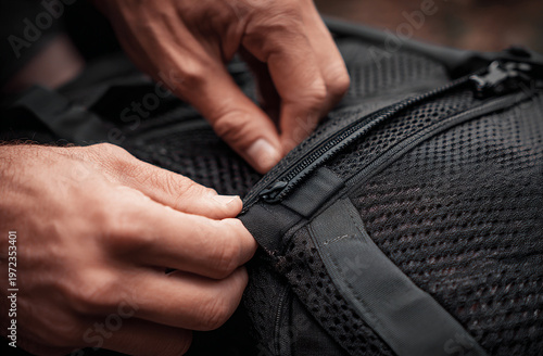 Close-up of person checking backpack frame and padding.