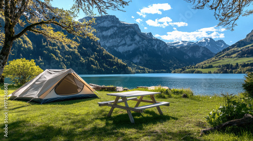 Camping tent table chair mountain lake outdoor nature summer scenic peaceful landscape with clear sky and green grass
