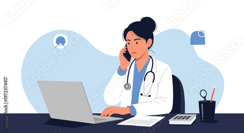 Professional female doctor in a white coat sits at her office desk using a laptop and talking on a mobile phone for a consultation.