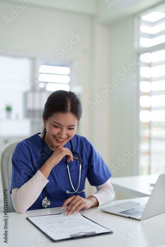 Canvas Print Asian adult healthcare professional reviews patient documents at modern clinic o