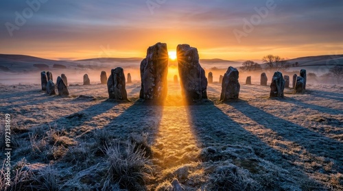 A field of ancient standing stones at winter solstice dawn, the alignment channeling the rising sun into a precise corridor between the tallest megaliths, golden light flooding