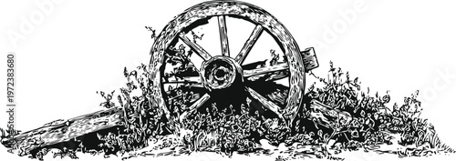 Old broken wooden wagon wheel lying in grass and wildflowers vintage rustic farm equipment