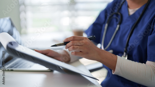 Obraz na plátně Healthcare professional diligently records patient information at a medical faci