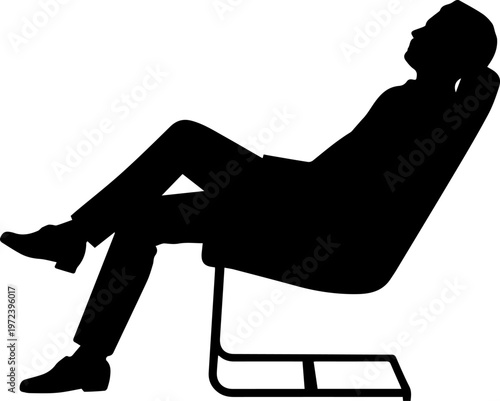 Silhouette of a man reclining in a comfortable armchair and relaxing