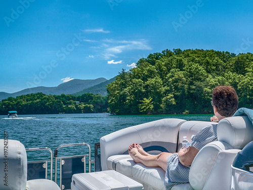 Φωτογραφία Woman sitting in a pontoon boat from behind