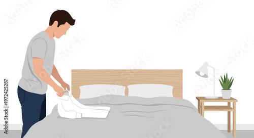 Man folding clothes on a bed in a modern bedroom