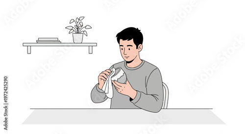 Man folding laundry at table, home interior, domestic chores, simple lifestyle