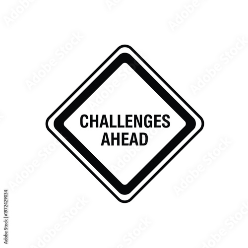 A stark black and white diamond shaped road sign warns of challenges ahead in bold uppercase lettering high quality professional