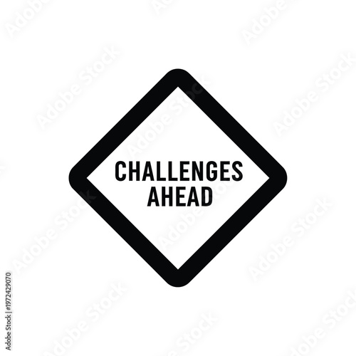 A stark black diamond shaped sign displays the text challenges ahead in bold capital letters against a white background
