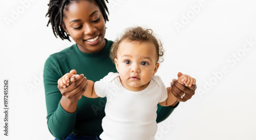 A smiling African American woman helping her baby take steps on transparent background