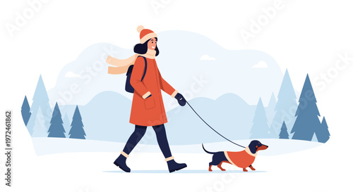 Young woman wearing a winter coat and scarf walks her cute dachshund dog through a peaceful snowy forest road.