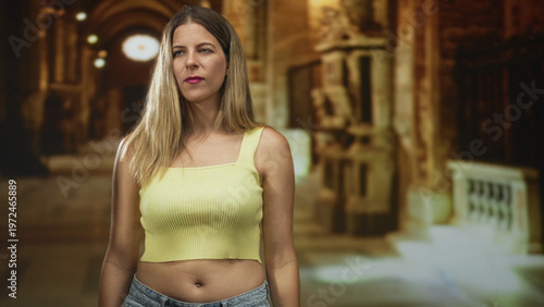 Wallpaper Mural Woman flexes bicep and shows midriff in a studio setting, raising arm in a muscle pose and looking aside; confidence. Torontodigital.ca