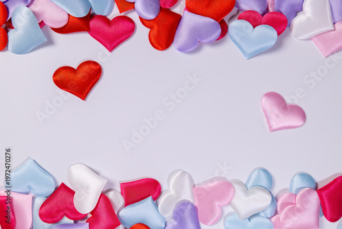 Multicolored hearts lie on a white background. Space for text.