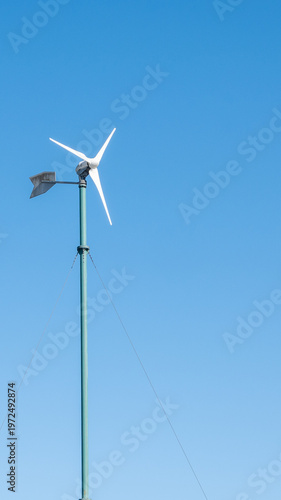 Landscape during sunset with road, fields and wind turbines. Windmills for energy production. Green energy in Germany.