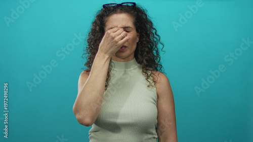 Billede på lærred Woman adjusting glasses in studio with closed eyes and scrunched face showing strained vision; annoyance
