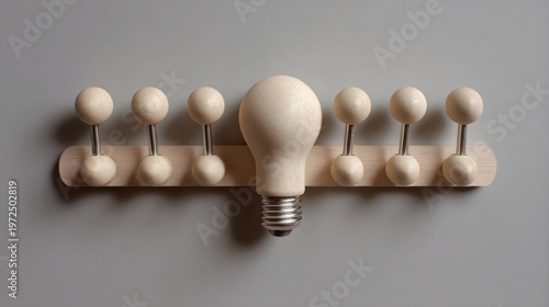 Wooden light bulb stands out among uniform balls on shelf