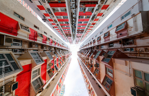 Wallpaper Mural Low angle view of residential towers in a community in Hong Kong; Dramatic scene of crowded narrow apartments in residential buildings, a phenomenon of high housing density due to overpopulation in HK Torontodigital.ca