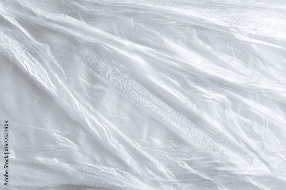 Obraz premium Plastic wrap covers a flat surface in a simple kitchen setting during daylight hours