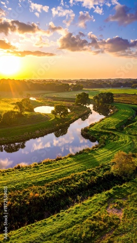 Serene Landscape with River at Sunset Overlooking Lush Green Fields