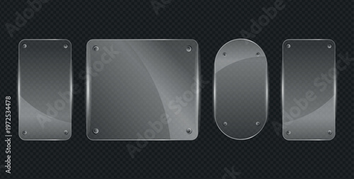 Variety of clear glass plates with rounded edges and rivets on dark background.