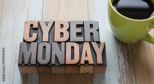 Cyber monday text in vintage letterpress blocks, beside a cup of coffee