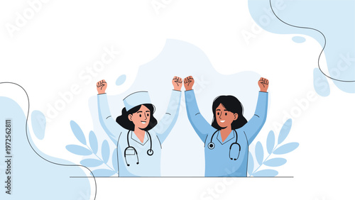 Two happy female doctors in blue scrubs raise their fists in a gesture of victory and professional empowerment.