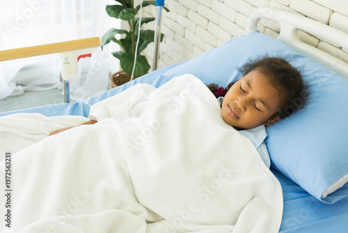 African american girl sleeping in hospital bed. Healthcare and medical concept.