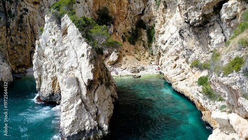 Foto Aerial view of the beautiful and hidden  Cala En Caló, and the anchorage in Cape La Nao, coast of the town of Jávea, Mediterranean Sea, Spain